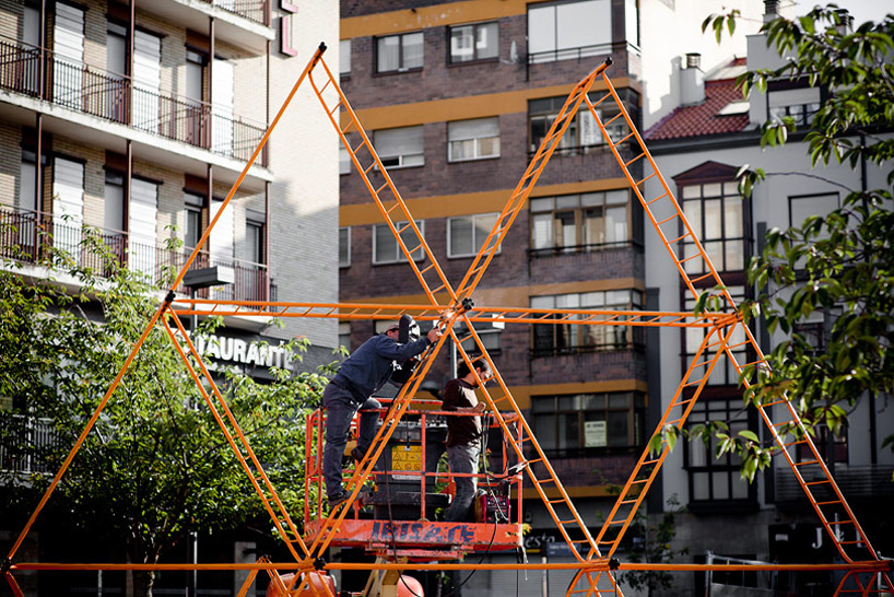 SpY urban art pyramid is constructed from safety barriers