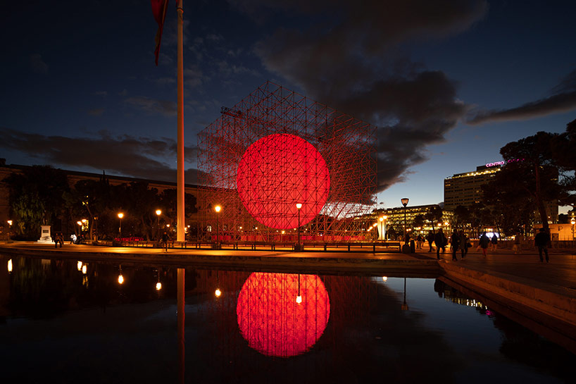 spy installs a huge luminous red sphere caged inside a structure in madrid 1