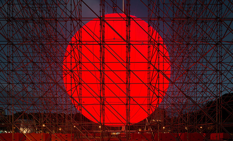 spy installs a huge luminous red sphere caged inside a structure in madrid 3