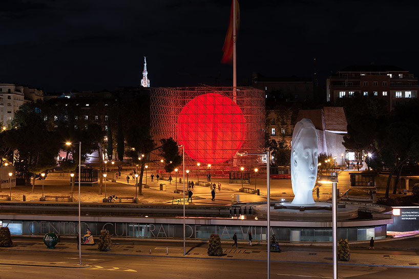 spy installs a huge luminous red sphere caged inside a structure in madrid 5