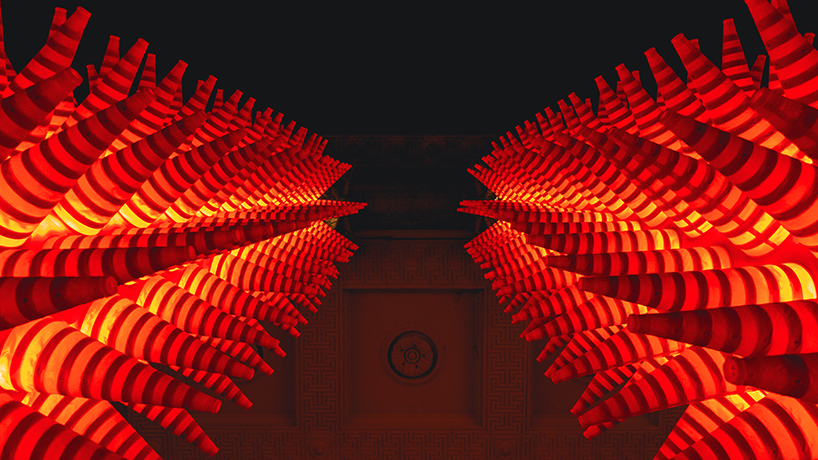 SpY wraps neoclassical columns in ghent with 1984 luminous traffic cones for lichtfestival
