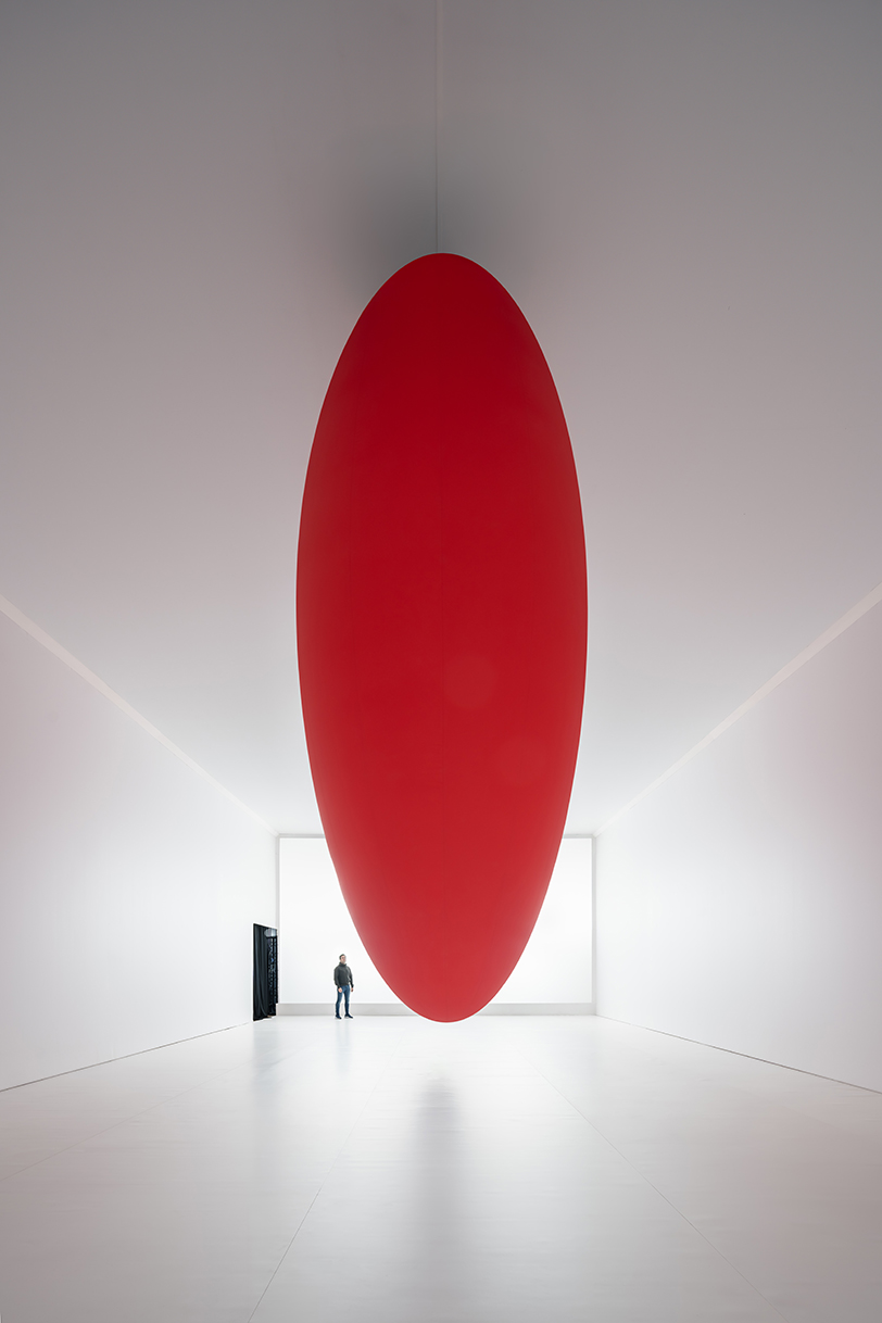 eight suspended red ovoids by SpY dance in pendular sequences