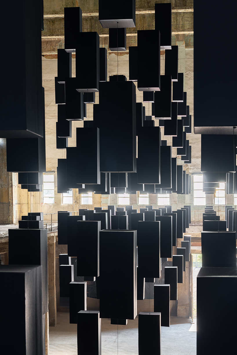 SpY's suspended grid installation of black rectangles floats within turbine factory in hungary