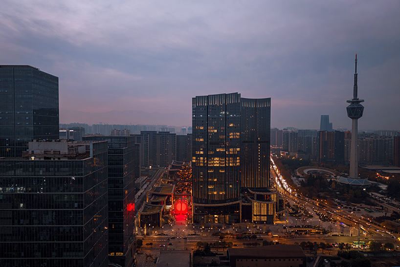 SpY's monumental divided sphere installation illuminates xi&rsquo;an in bright red light