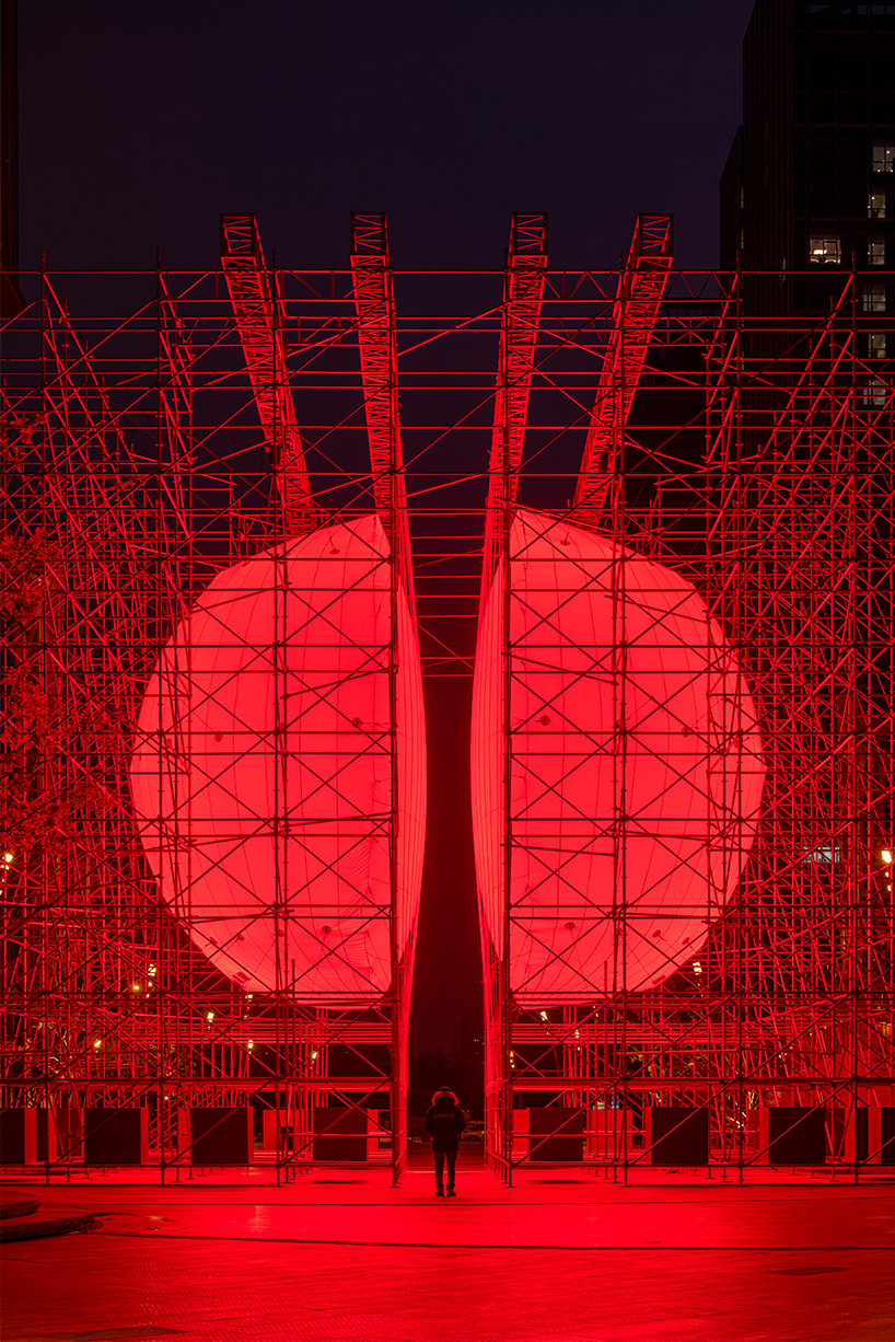 SpY's monumental divided sphere installation illuminates xi&rsquo;an in bright red light