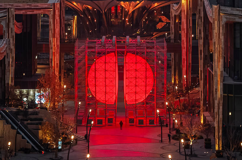 SpY's monumental divided sphere installation illuminates xi&rsquo;an in bright red light
