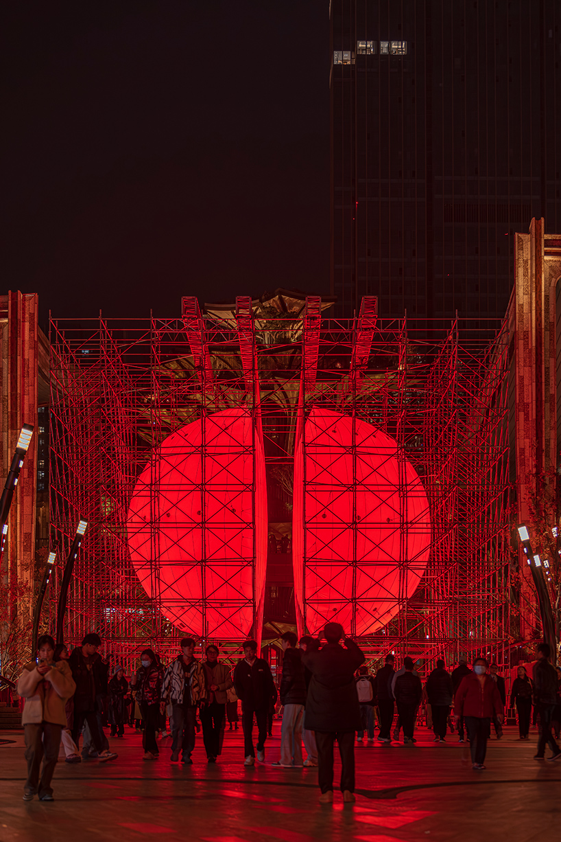 SpY's monumental divided sphere installation illuminates xi&rsquo;an in bright red light