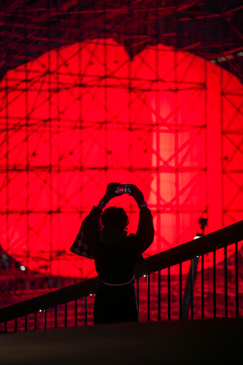 SpY's monumental divided sphere installation illuminates xi&rsquo;an in bright red light