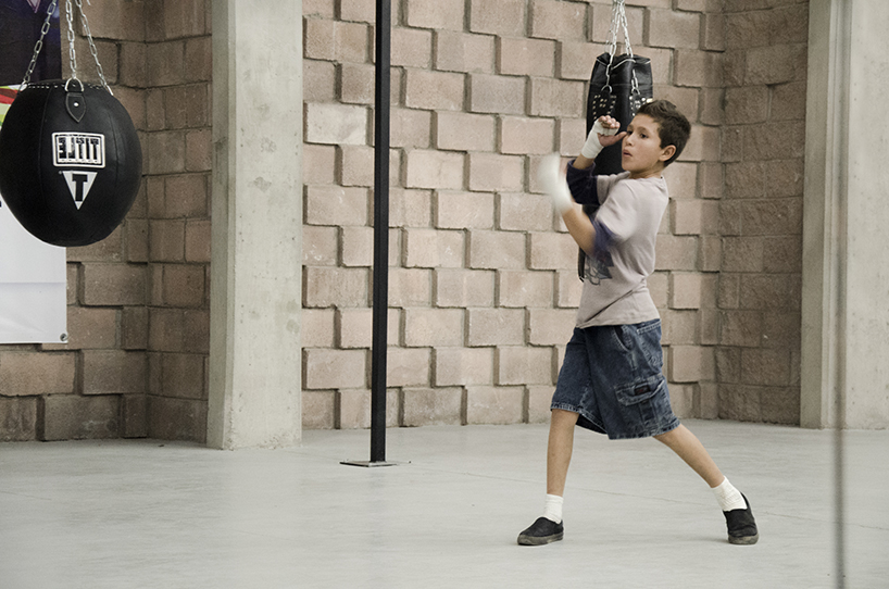 urbanika utlizes rough brick pattern for community boxing gym