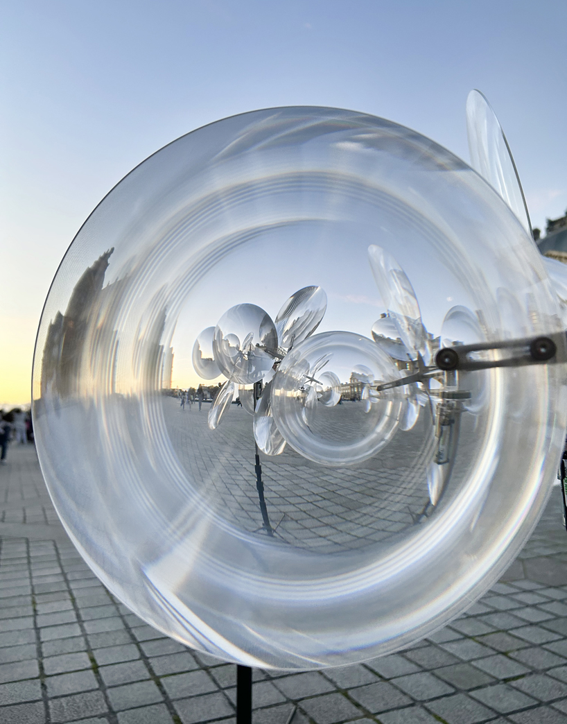 kinetic cloud's floating lenses by vincent leroy deform louvre's facade