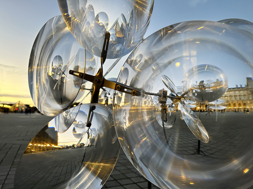 kinetic cloud's floating lenses by vincent leroy deform louvre's facade