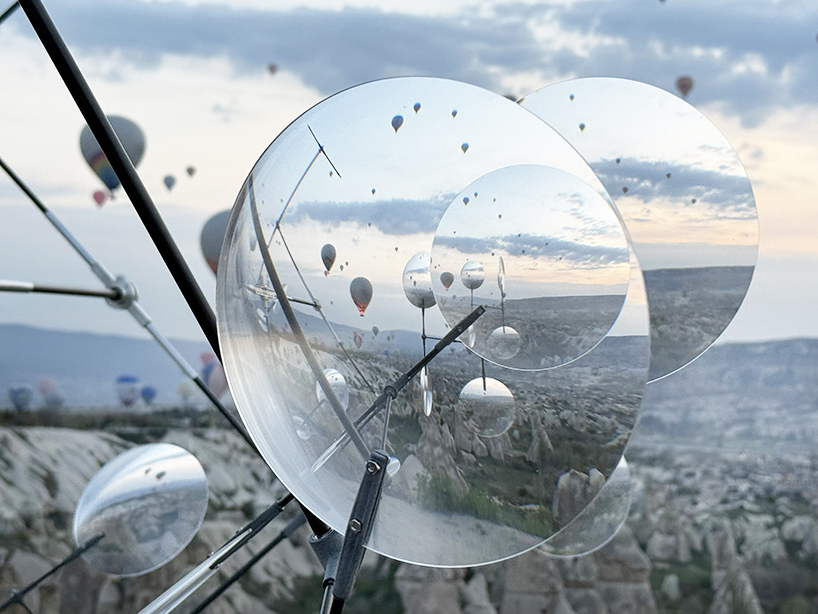 vincent leroy's optical mobile of floating lenses dances with hot air balloons over cappadocia