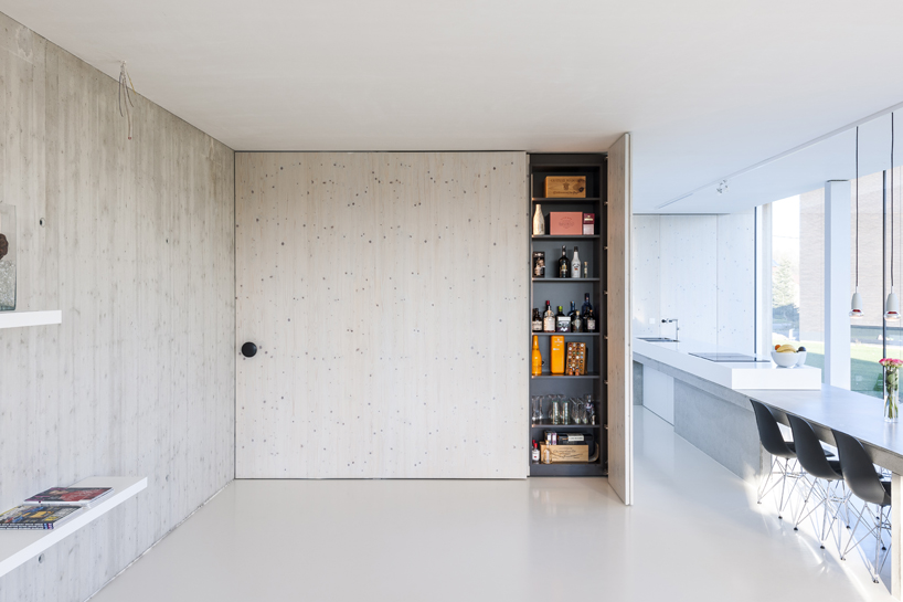 dmoa architects' screen house frames the gently sloping fields of belgium's countryside