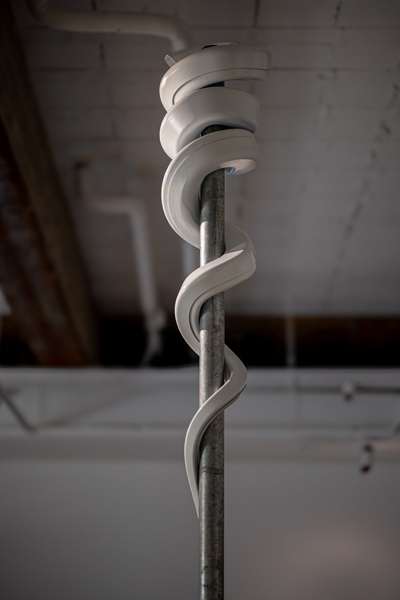 jakub geltner bends surveillance cameras into curved installations for exhibition in belgium