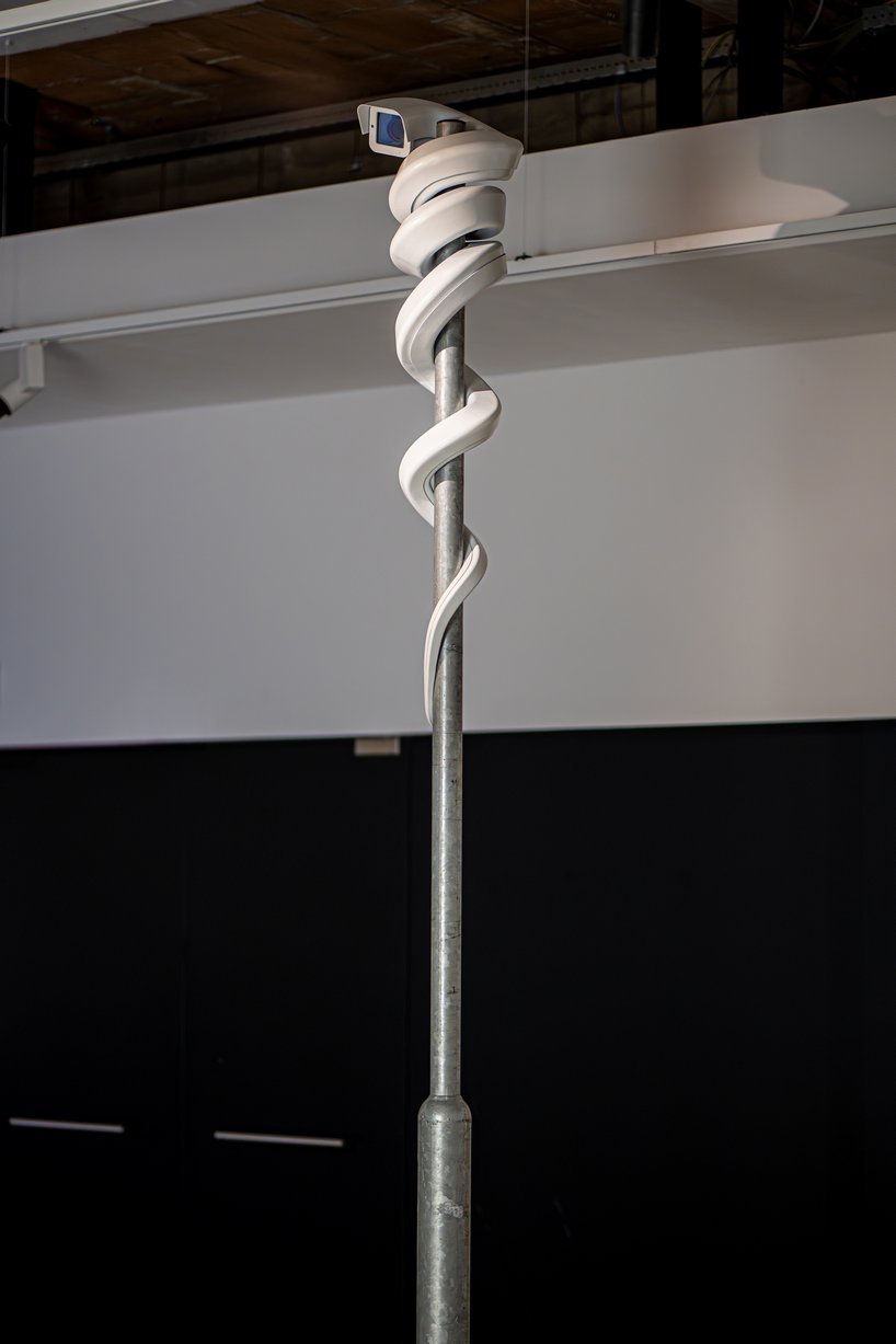 jakub geltner bends surveillance cameras into curved installations for exhibition in belgium