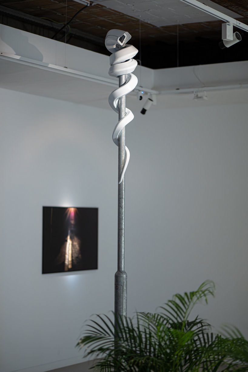 jakub geltner bends surveillance cameras into curved installations for exhibition in belgium