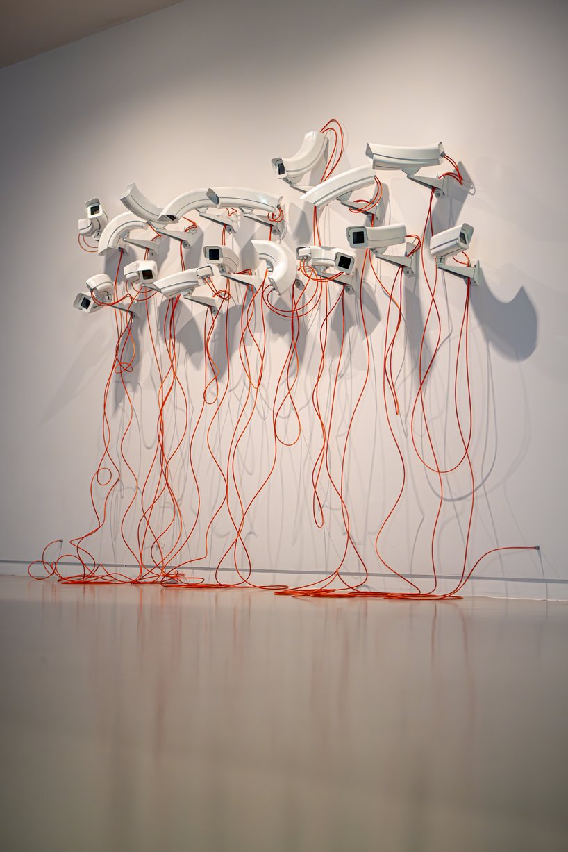jakub geltner bends surveillance cameras into curved installations for exhibition in belgium