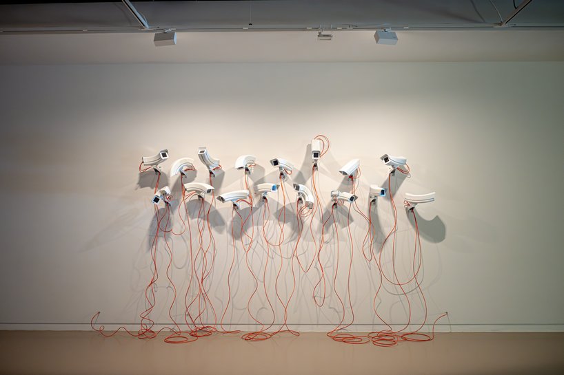 jakub geltner bends surveillance cameras into curved installations for exhibition in belgium