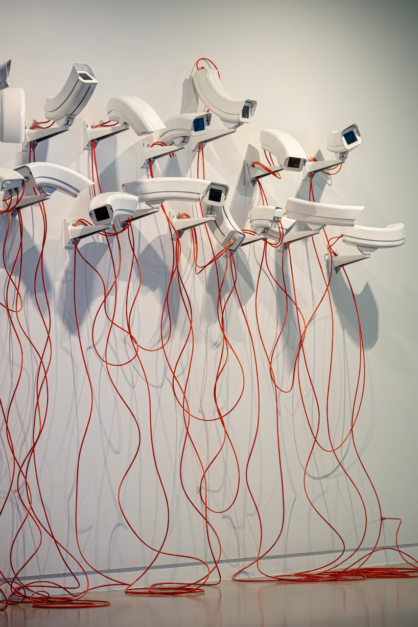 jakub geltner bends surveillance cameras into curved installations for exhibition in belgium