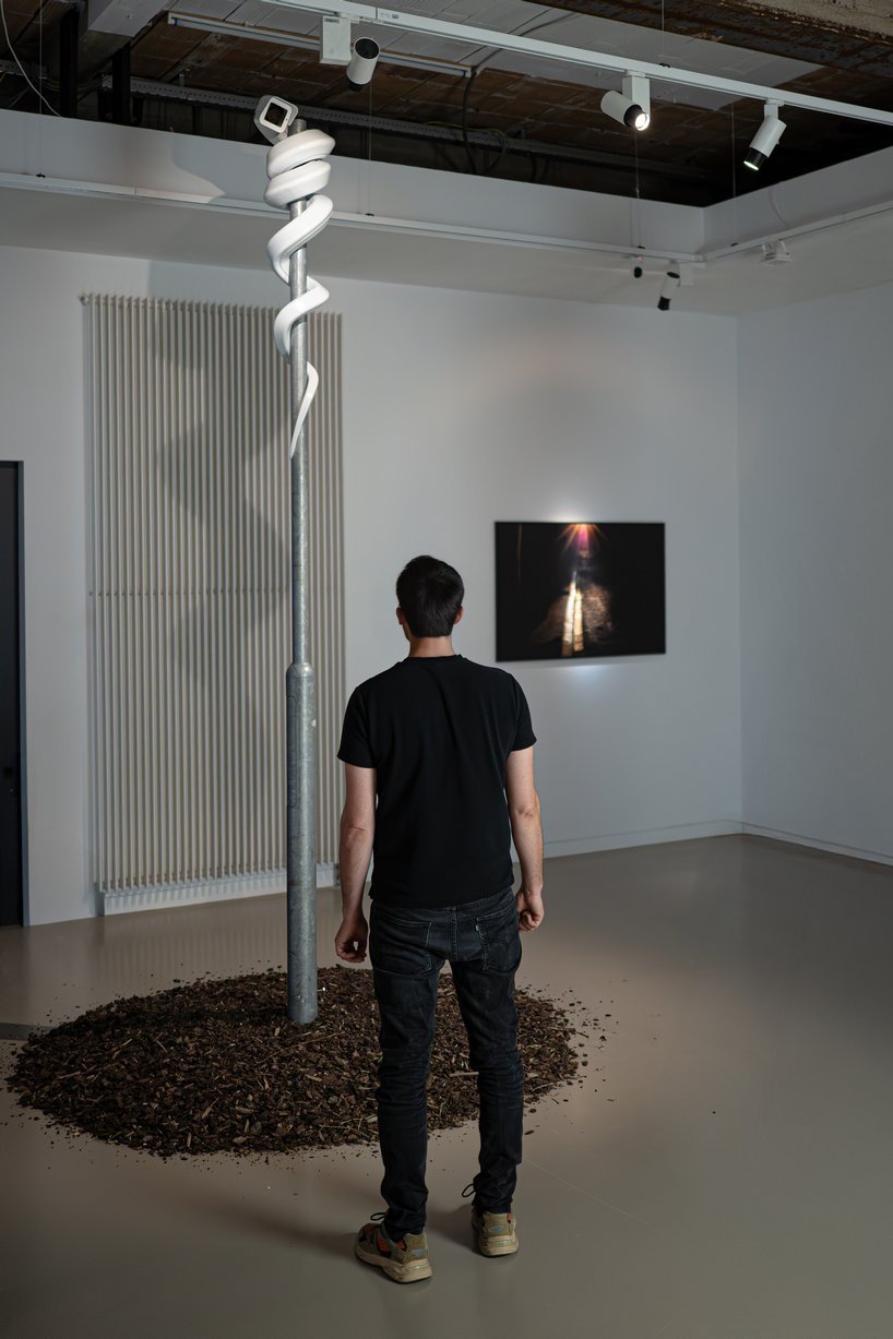 jakub geltner bends surveillance cameras into curved installations for exhibition in belgium