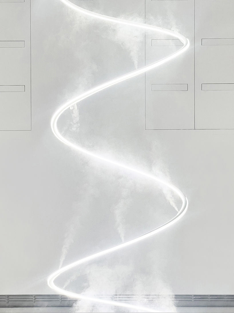 giant spiralling installation by karolina halatek immerses spectators in light + fog