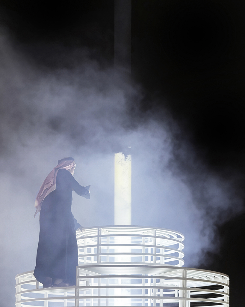 reflective pyramidal monument emits sky-tracing beam of white light in saudi arabia