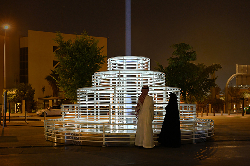 reflective pyramidal monument emits sky-tracing beam of white light in saudi arabia