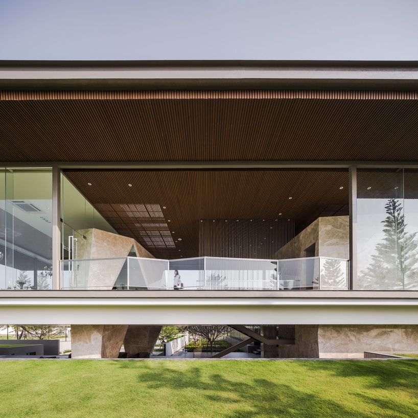 office at floats transparent box over stone formations for the grand ...