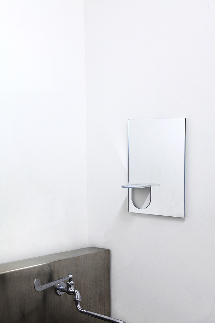the U mirror by studio yumakano features a functional folded shelf