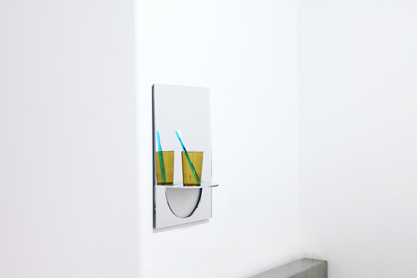 the U mirror by studio yumakano features a functional folded shelf - 1
