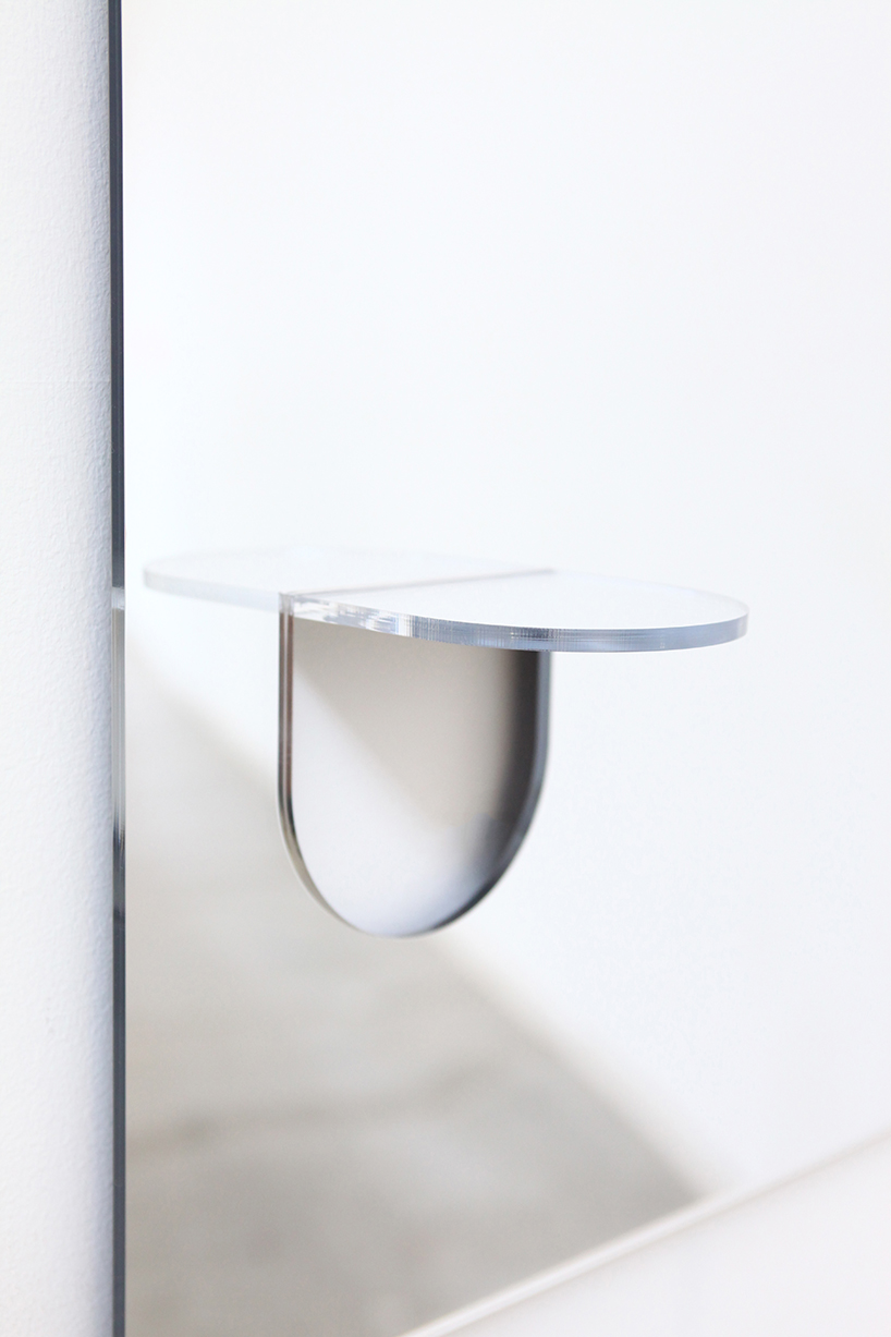 the U mirror by studio yumakano features a functional folded shelf