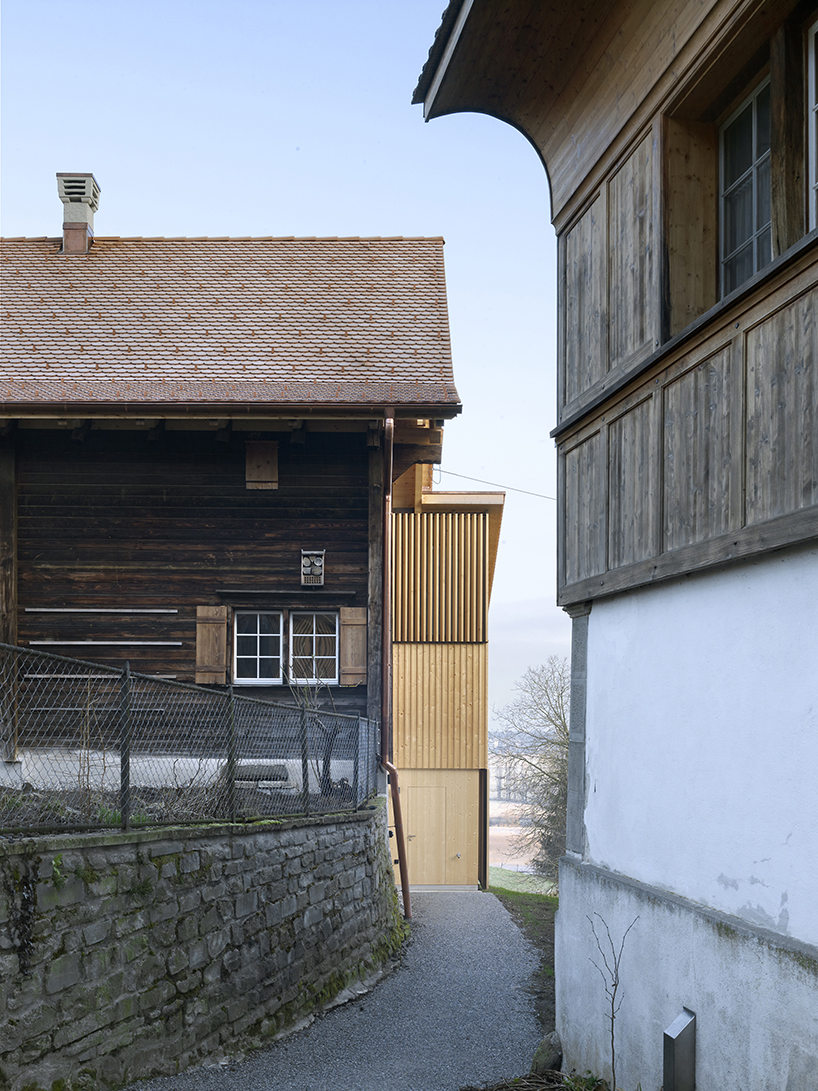 historically protected farmhouse in switzerland gets second life through kit architects' renovation