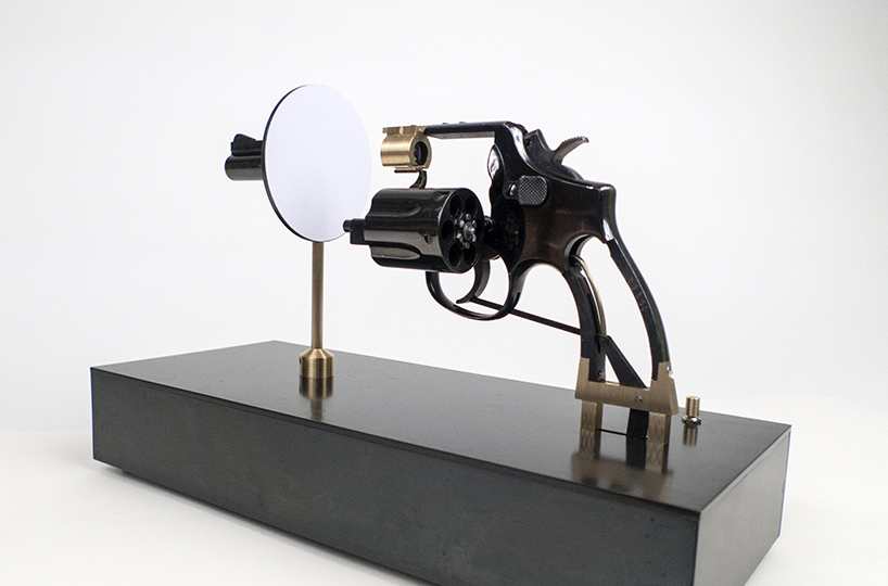 artist constantine zlatev transforms a revolver into a slide projector in tribute to nonviolent resistance