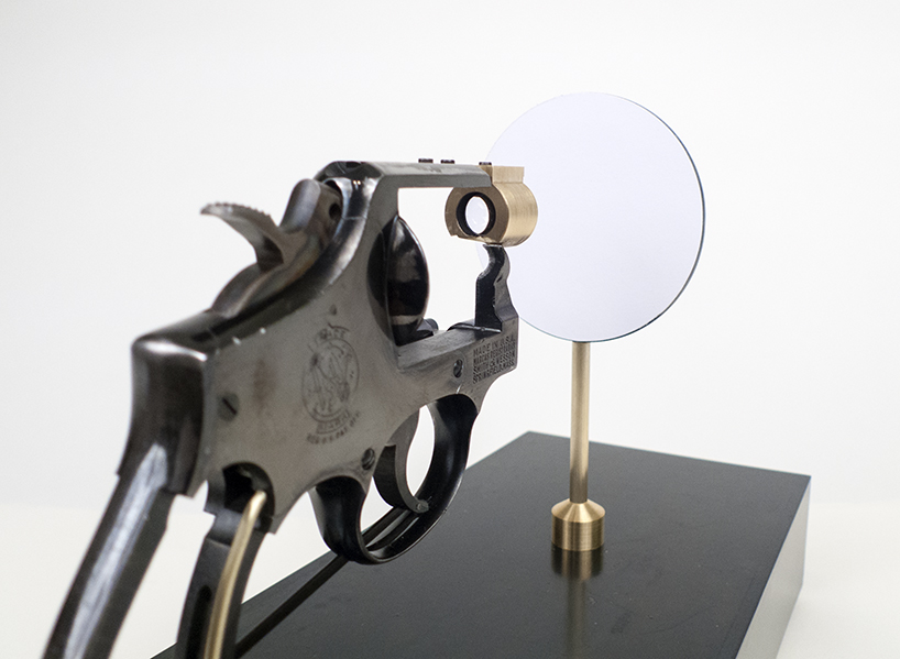 artist constantine zlatev transforms a revolver into a slide projector in tribute to nonviolent resistance designboom