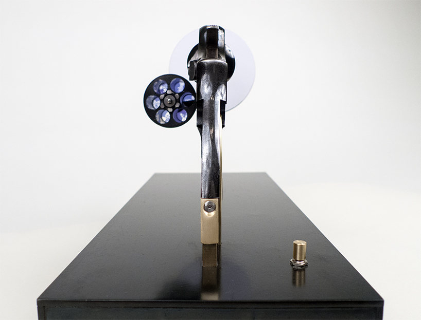 artist constantine zlatev transforms a revolver into a slide projector in tribute to nonviolent resistance designboom