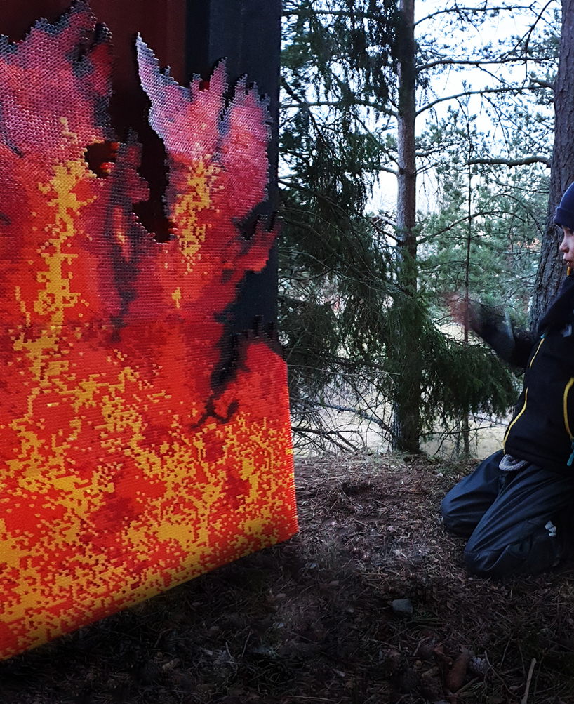 UMA installs a spectacular fire-like lighting system in a swedish forest