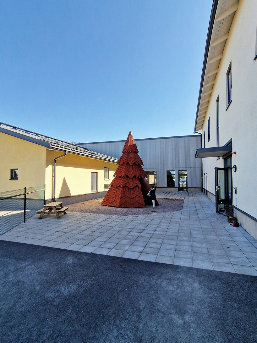 UMA nestles children's library inside spruce tree-shaped installation in sweden