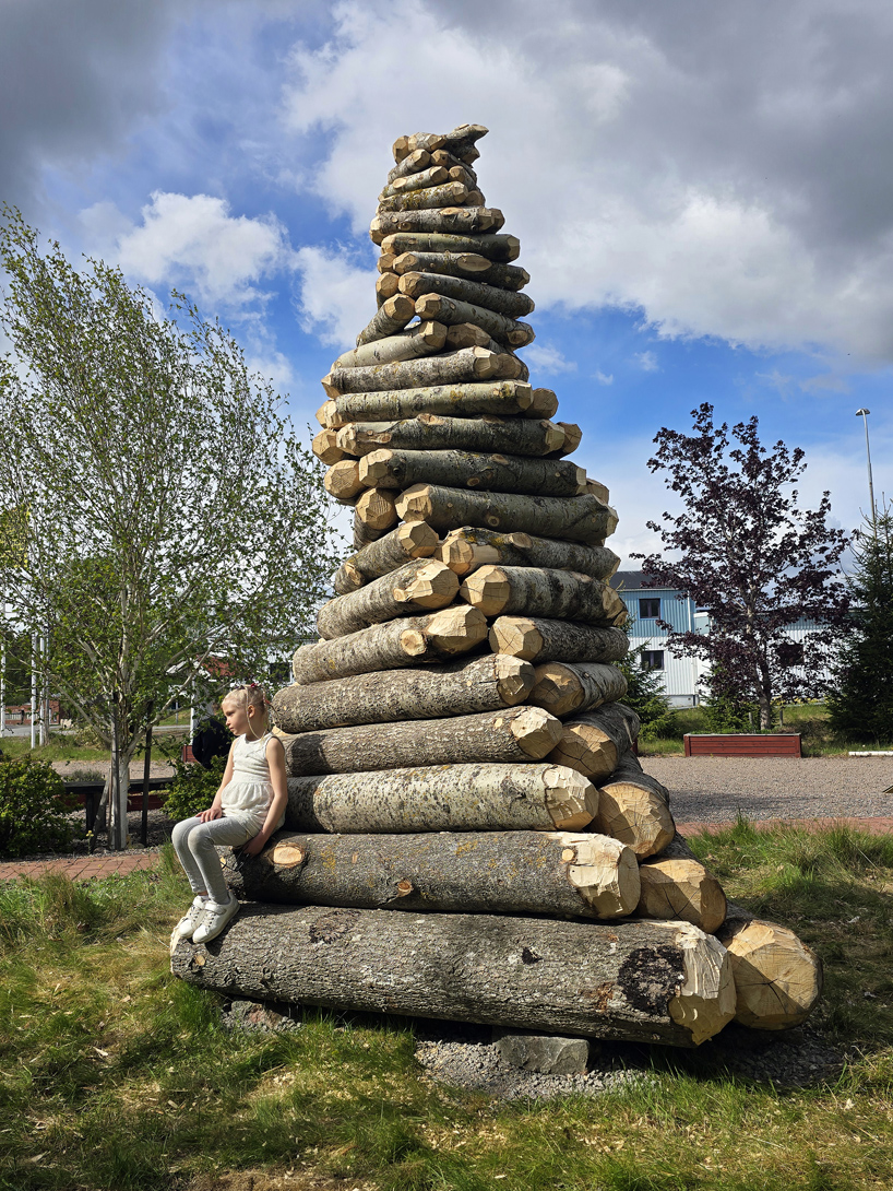timber twist by ulf mejergren and travis child reimagines larvae shelter as spiraling log cabin