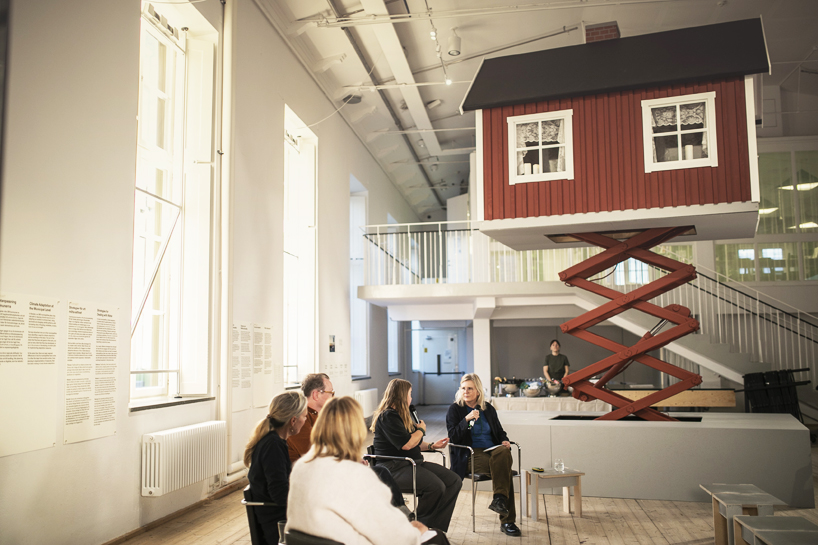 ulf mejergren builds mobile red cottage on scissor lift as a response to climate change