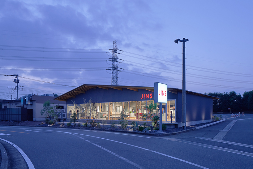 gentle gable roof overcasts wooden frame of eyewear store in japan