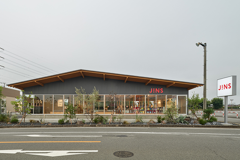 gentle gable roof overcasts wooden frame of eyewear store in japan