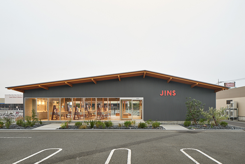 gentle gable roof overcasts wooden frame of eyewear store in japan