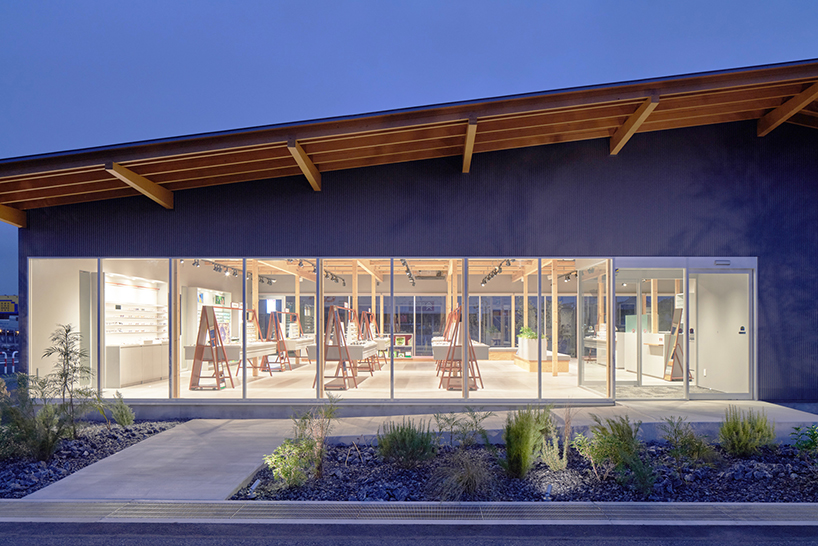 gentle gable roof overcasts wooden frame of eyewear store in japan
