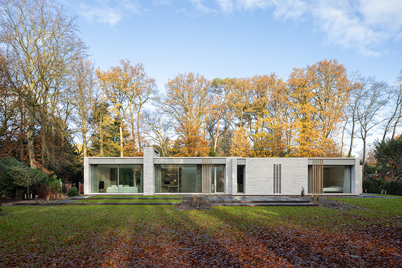 Contemporary residence in the Netherlands unfolds four volumes around an open patio