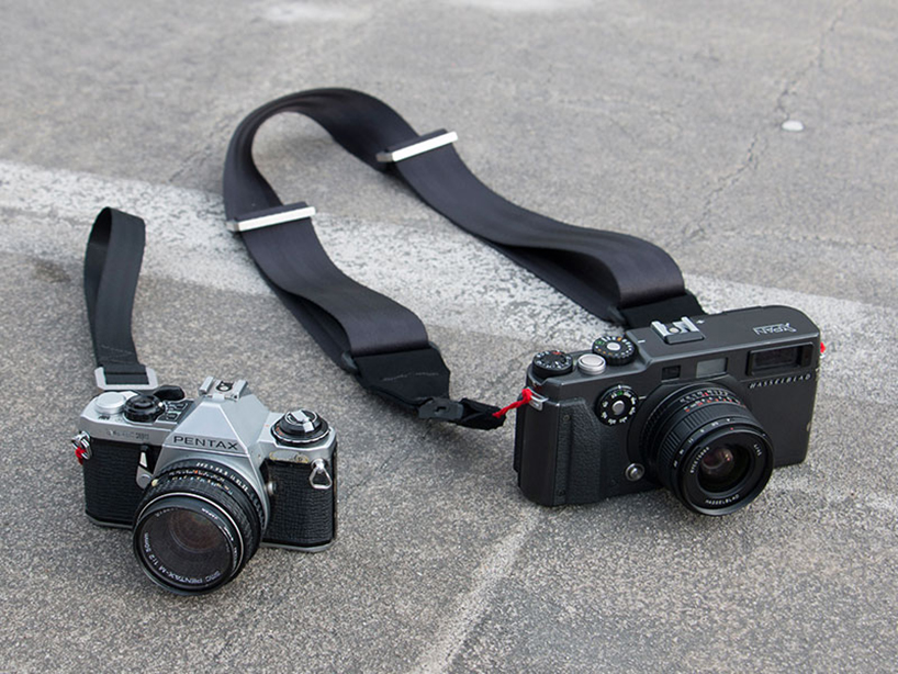 Seatbelt camera outlet strap