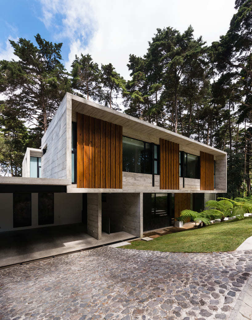 paz arquitectura's exposed concrete house in guatemala contrasts with surrounding woods