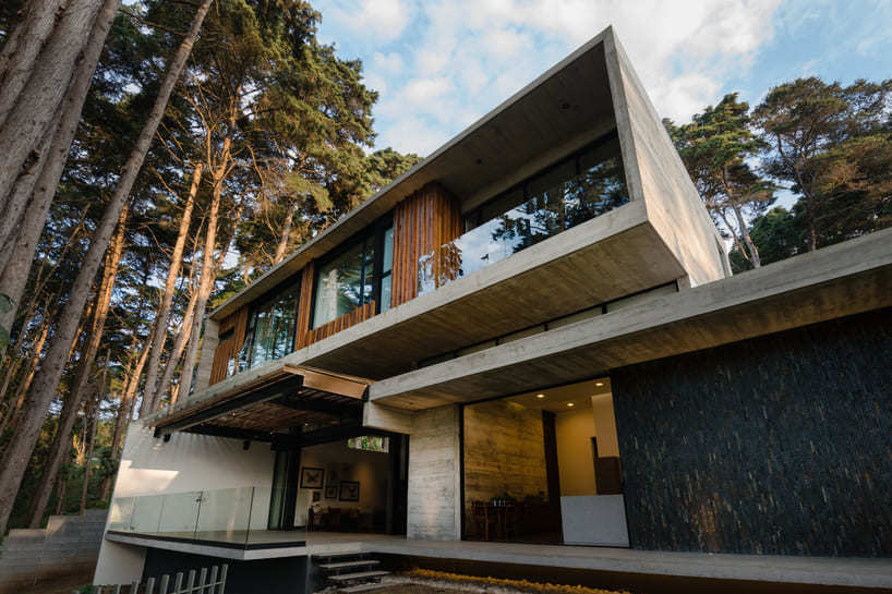 paz arquitectura's exposed concrete house in guatemala contrasts with surrounding woods