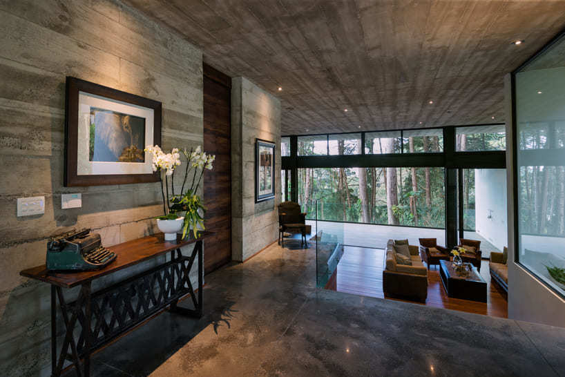 paz arquitectura's exposed concrete house in guatemala contrasts with surrounding woods