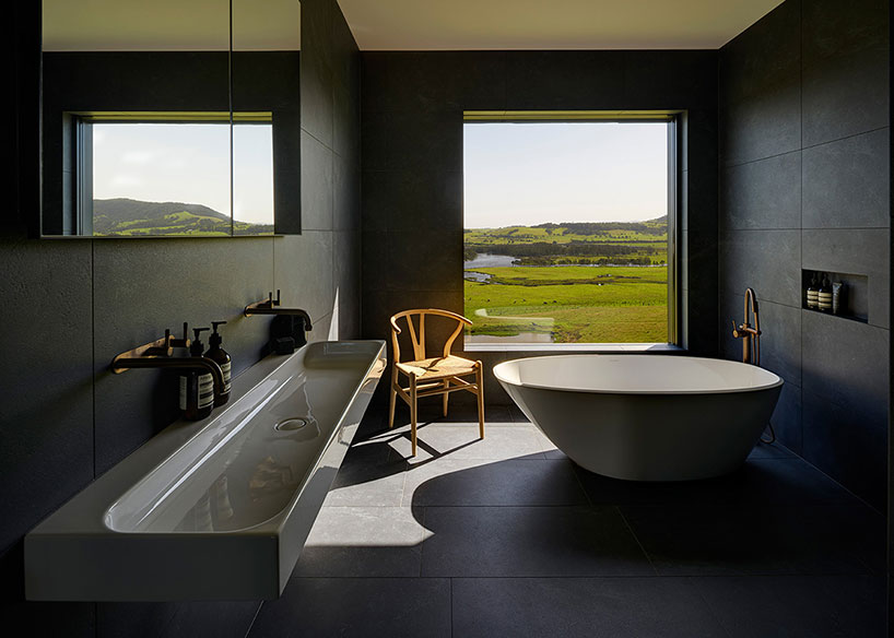 australian beach house creates farmland sanctuary from wild ocean surroundings