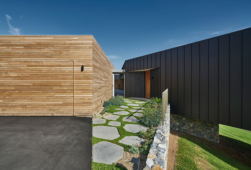 australian beach house creates farmland sanctuary from wild ocean surroundings